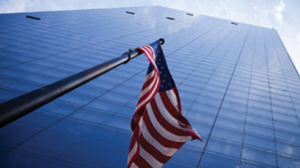 US Flag in front of skyscraper