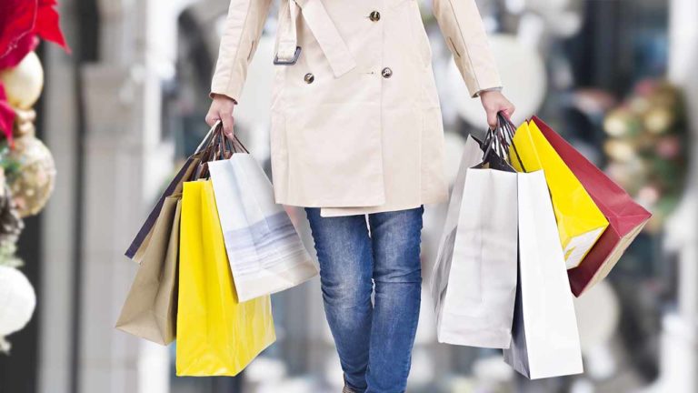 Woman walking with retail shopping bags