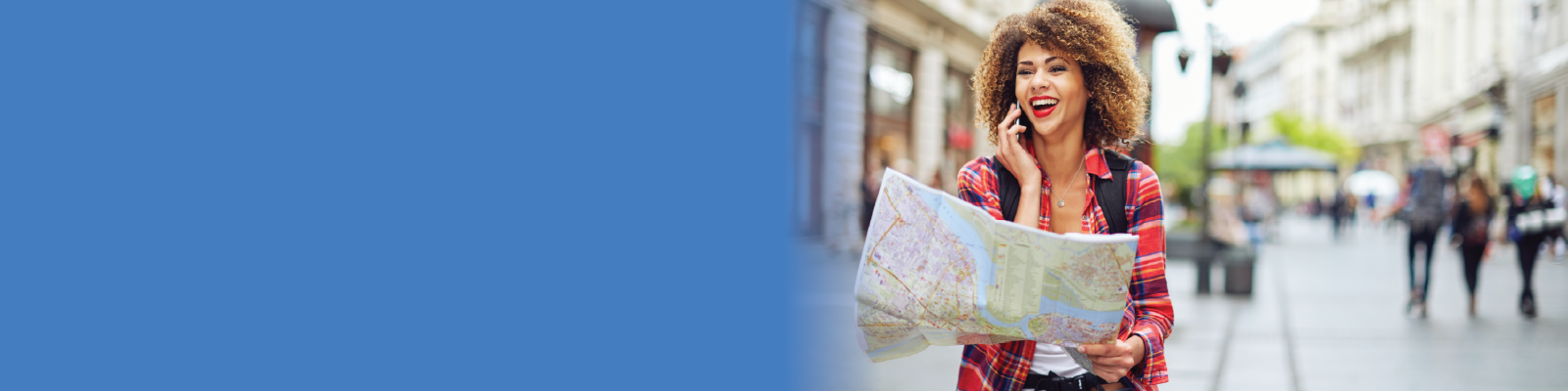 Header image showing young female traveler holding map, on the phone