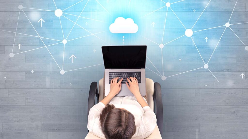 Cloud and network icon near woman working on laptop