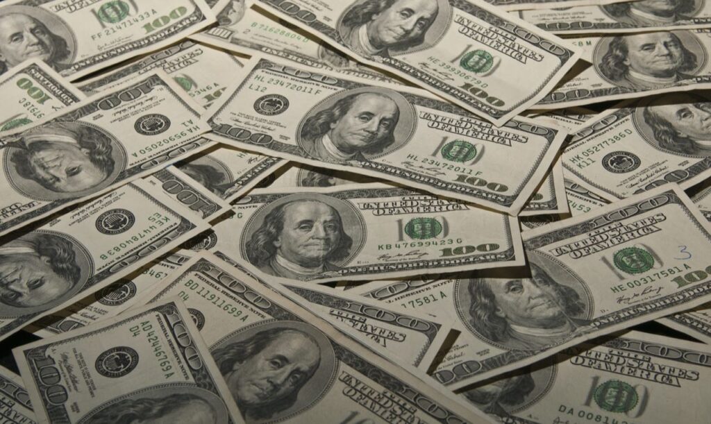 horizontal surface covered in $100 bills