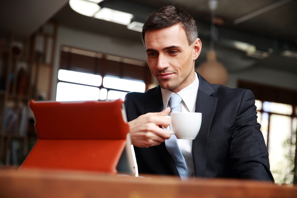 Businessman reading, with coffee