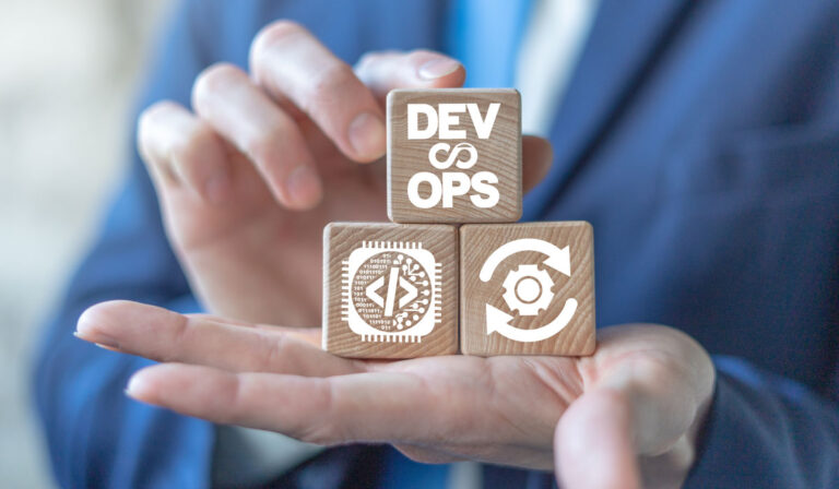 Hands holding building blocks with icons for code, devops, gears