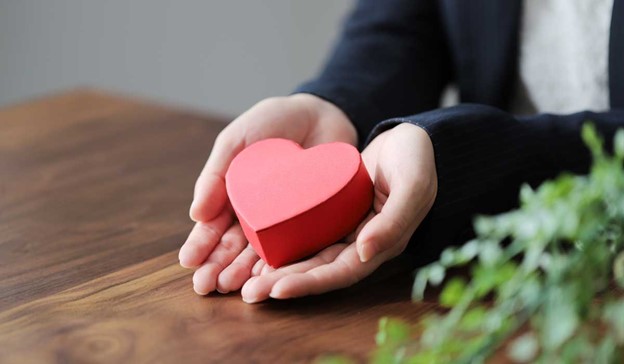 two hands holding heart-shaped object