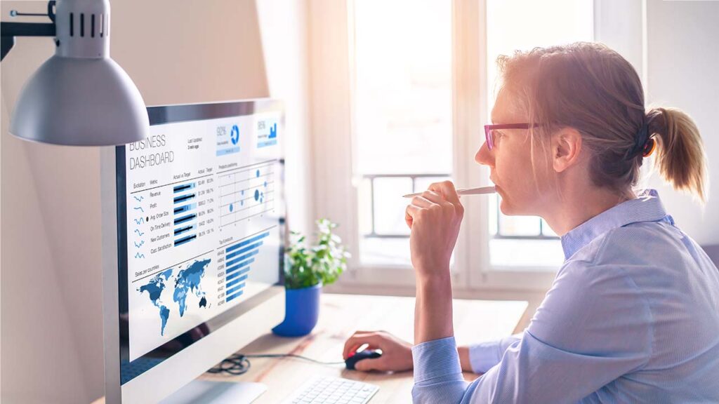Woman looking at business dashboard onscreen