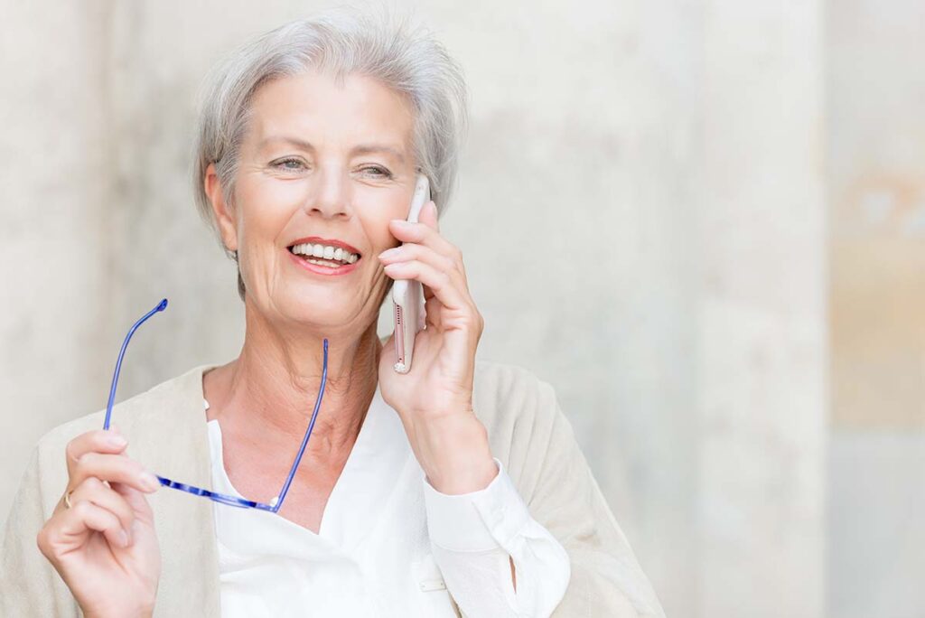 Older woman laughing while speaking on phone