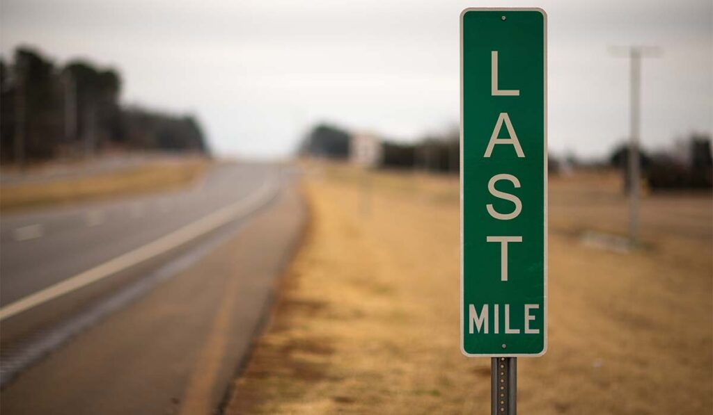 Roadside milepost sign "Last Mile"