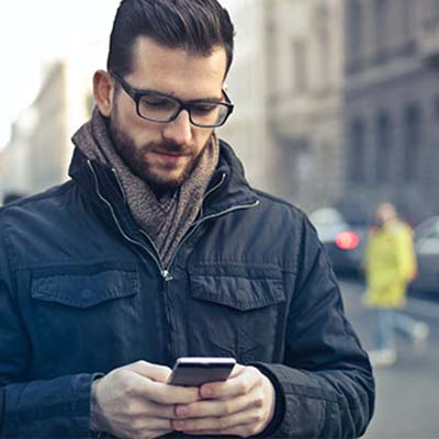 Man looking at phone with serious expression