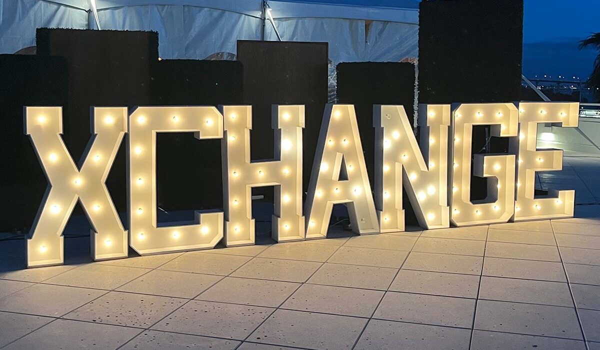 Xchange 2024 illuminated sign on hotel patio