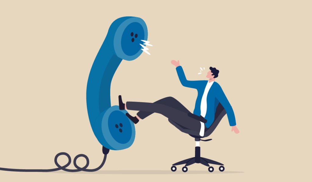 A man sitting with a giant phone.